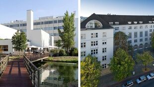 Links ein moderner Gebäudekomplex mit Holzsteg über Wasser, rechts ein historisches mehrstöckiges Gebäude mit Satteldach und parkenden Autos davor.