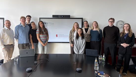 Gruppe von Menschen vor einer weissen Tafel