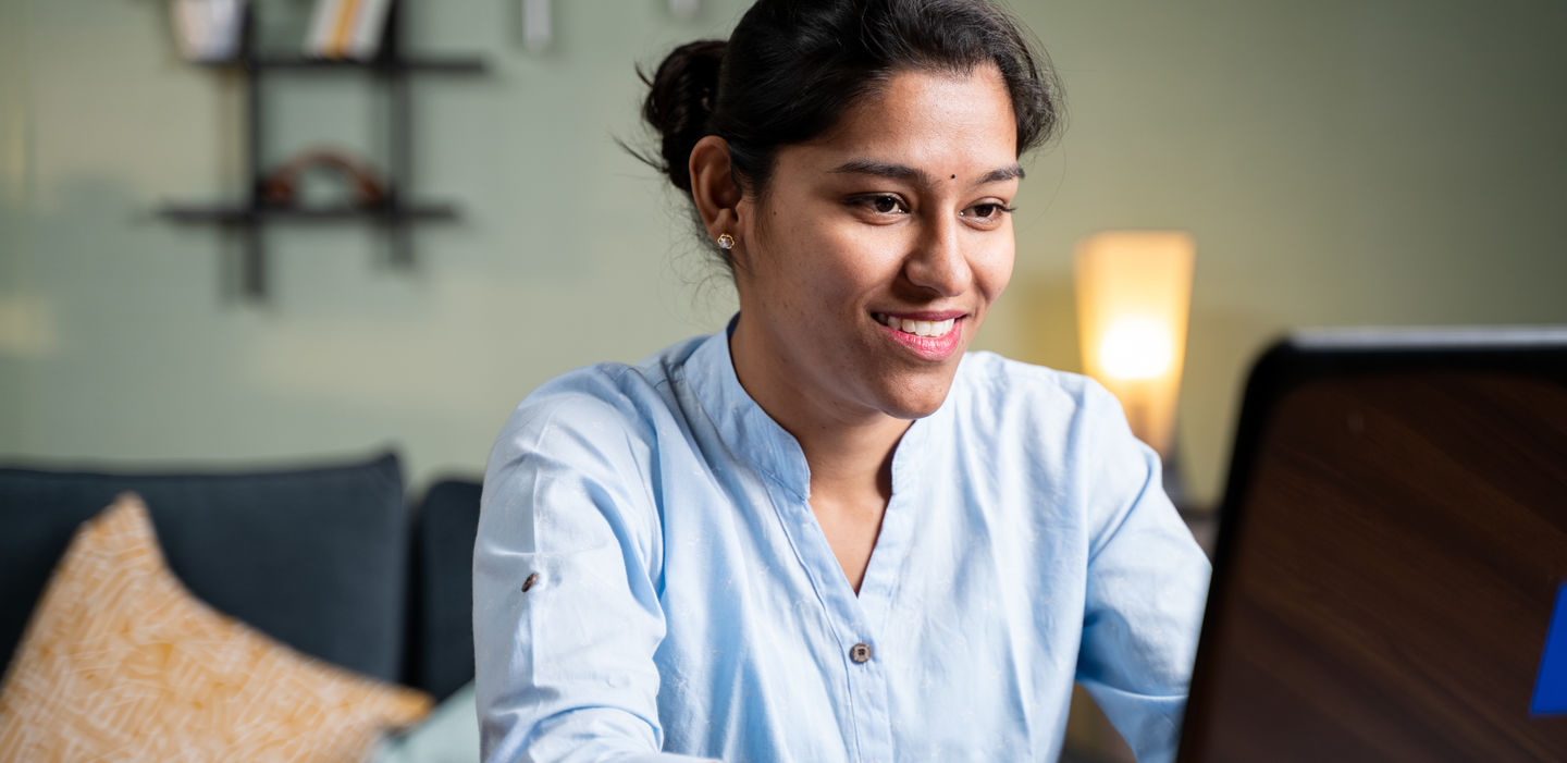 Bewerben fürs Wintersemester 2022/23 an der HWR Berlin. Foto: © lakshmiprasad S/iStock/Getty Images Plus Studierende bereitet am Laptop ihre Bewerbung vor und lächelt dabei. Foto: © lakshmiprasad S/iStock/Getty Images Plus