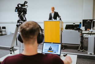 Berlin International Week an der HWR Berlin: Studierender am Laptop verfolgt mit Kopfhörern die Eröffnungsrede von Prof. Dr. Andreas Zaby, Hochschulpräsident der HWR Berlin. Foto: Oana Popa-Costea